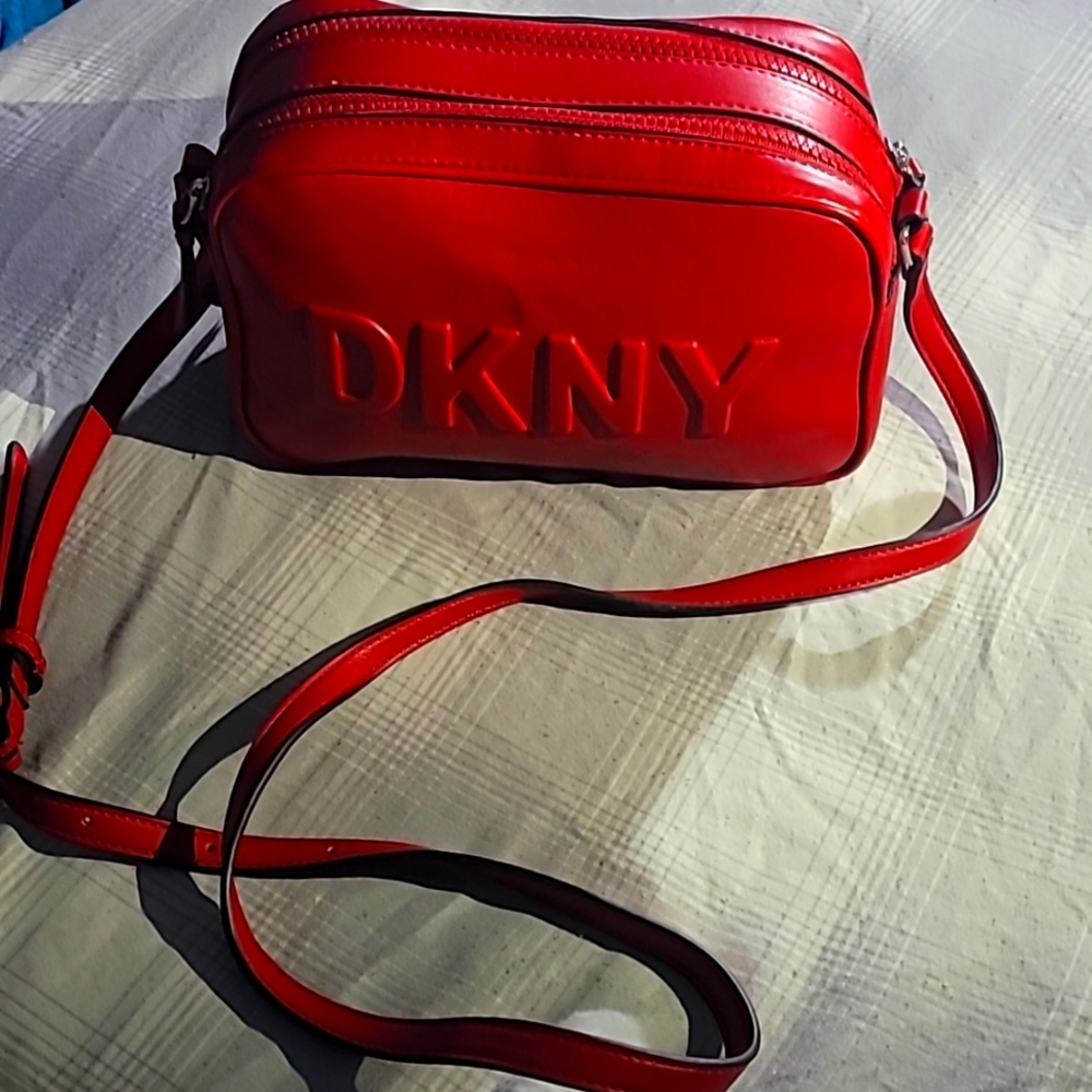 For sale is a new, elegant DKNY bag with a single strap.